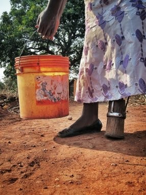 Woman with disability carrying water