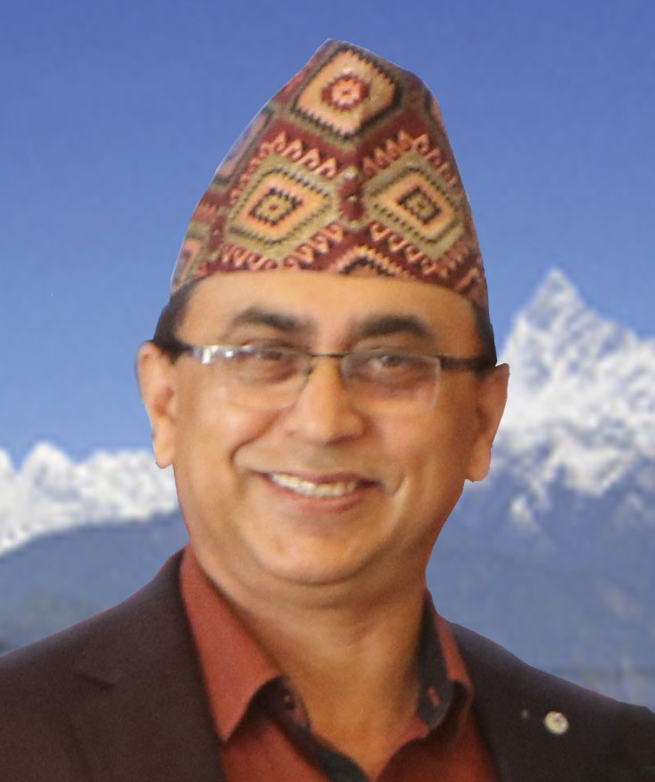 Photo of Bharat Adhikari smiling at the camera. He is wearing glasses and a hat.